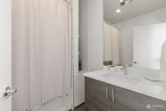 Hallway bathroom is a fully bathroom with tub and shower.