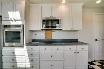 Newer range top and wall oven is Kitchenaid brand appliances.