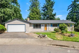 Charming North Hill rambler with fresh curb appeal! Featuring a two-car garage, classic wood front door, wide driveway, and clean exterior siding, this home makes a welcoming first impression. Mature evergreens in the backdrop add a true Pacific Northwest feel.