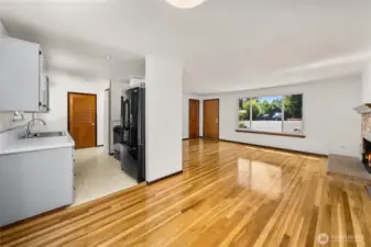 Open dining space that flows effortlessly into both the updated kitchen and the living room. Featuring durable hardwoods, neutral paint, and sightlines to the front yard through quadruple-pane windows, this layout is ideal for everyday living and gatherings.