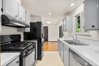 Classic galley design with ample storage and direct sightlines to the dining area and backyard. Neutral finishes make this space move-in ready and easy to customize with your own style.