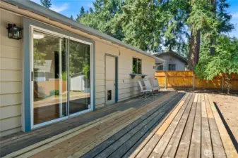 Sliding glass doors lead directly from the dining area to the expansive deck, blending indoor and outdoor living with ease.