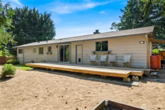 Another angle of the backyard shows the home’s deck space and easy-maintenance yard, ready for personalization.