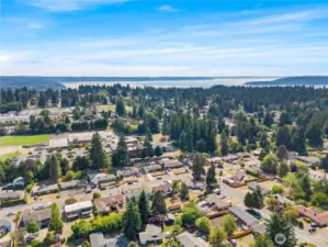 Just minutes from the new Light Rail station, SeaTac Airport, I-5, and halfway between Seattle & Tacoma — North Hill offers unbeatable convenience. The aerials also showcase the tree-lined community, nearby schools, and even views of Puget Sound in the distance.
