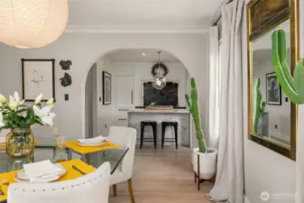 Through a graceful archway, the dining room flows into the exquisite kitchen.