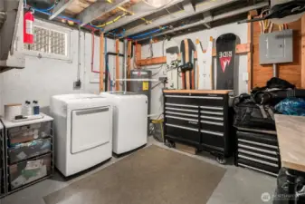 A dedicated laundry area with full-size washer and dryer pairs with a versatile storage and workroom, complemented by all-new PEX plumbing and updated home systems for modern convenience and peace of mind.