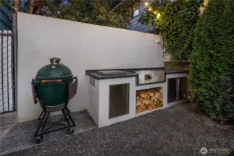 An entertainer’s dream, the outdoor kitchen features wood storage and stainless-steel cabinetry—all designed for year-round cooking and gathering. *Plumbed for a 32" gas grill!!*
