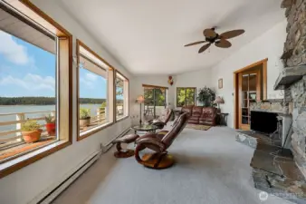 Lovely open floor plan with wood burning fireplace insert. The spacious layout promotes excellent flow between living areas, creating a warm and inviting atmosphere perfect for relaxation and entertainment.