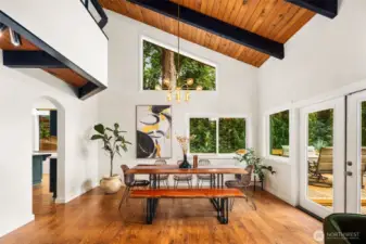 Dining room with french doors to the deck, kitchen off to the left.