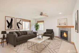 Family room with gas fireplace and ceiling fan.  virtually staged.