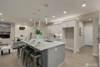 A graceful transition from kitchen to dining and living spaces enhances both daily living and sophisticated entertaining, making the heart of the home truly the center of connection.
