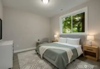 A thoughtfully positioned main-floor bedroom offers flexible living — ideal as a mother-in-law suite, guest retreat, home office, or for multi-generational comfort. [Photo is virtually staged]