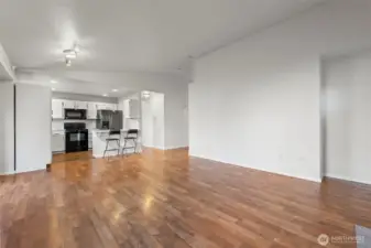 From left corner of living room looking at the kitchen