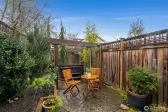 Enjoy your private rear patio with newer hot tub & mature shrubs