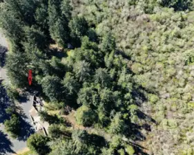 This shows the space of the property with the arrow showing the RV parking area. Property just under an acre.