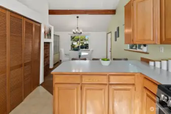 Kitchen overlooks dining area. Side door leads outside.