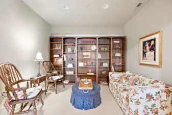 This cozy library nook has built-in shelving that provides ample storage space for books and other items. It's the perfect place to curl up with a good book.