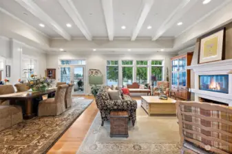 This home has a formal dining area and a cozy living room that includes a raised wood-burning fireplace, built-in cabinetry, and a gorgeous lake view!