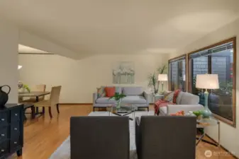 From the entry, you are greeted by the main living room and dining room beyond.