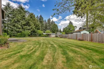 Now that's a backyard! Look at all the space and privacy! In the corner, there are storage sheds and two carports.