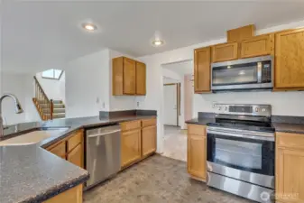 Here's another view of the kitchen with the microwave, range/oven and dishwasher. The breakfast bar is large and can sit at least six people very comfortably.