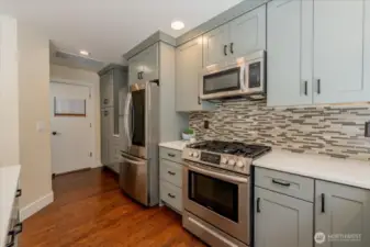 View to the hallway to 1/2 bath and Garage Door
