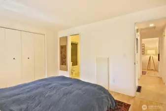 Primary bathroom is to the left and the second bedroom/office is to the right. Main Bathroom is off of the hallway (left side of hall) in between the two bedrooms.