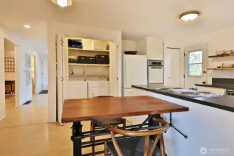 Kitchen has washer/dryer and the hot water heater is located to the right in closet near the door.