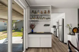 From dining room looking towards bar, back slider door, and kitchen