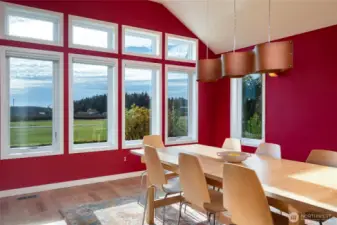 Spacious formal dining or music room highlighted by vaulted ceilings and expansive windows.