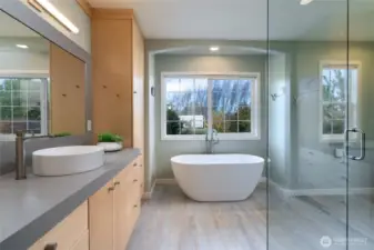 Beautiful primary ensuite bathroom with a glass/concrete shower and a slipper bathtub.