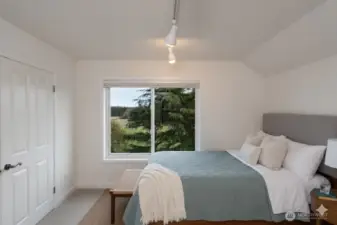 Large bedroom with a view of Mt. Baker. Virtually staged.