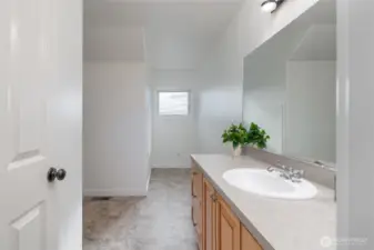 Second-floor full bathroom positioned beside a spacious supply closet for added storage.