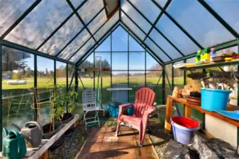 A large glass greenhouse for year-round growing.
