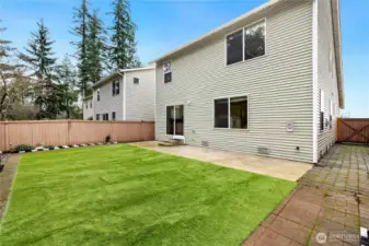 Low maintenance backyard with bricks on walking paths and side yards.