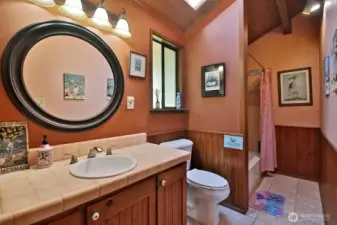 Upper bathroom with tub and shower.