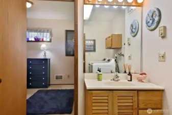 Utility room & bath lead into an additional flex space.