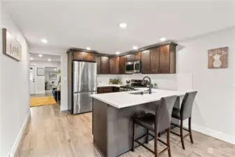 View of the Kitchen leading into the Family Room and further, into the Den. Room here for everything!