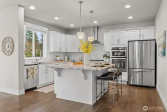 Beautiful kitchen with SS appliances and white shaker cabinets.