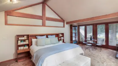 Primary suite located in its own wing with private deck sporting serene views of the lake.