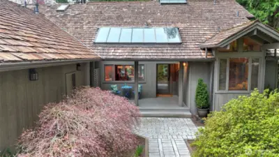 The covered front porch provides additional space to enjoy the lush landscape of this exceptional property.