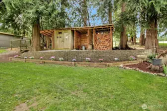 The woodshed alongside the large chicken coop with a huge run.