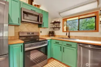 The kitchen with newer appliances and a view of the property