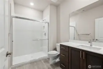 Bedroom 3 bathroom with stand up shower and glass surround. Photo rendering is representational. Actual home is under construction and finishes, elevation, and paint colors may vary. See site agent for details.