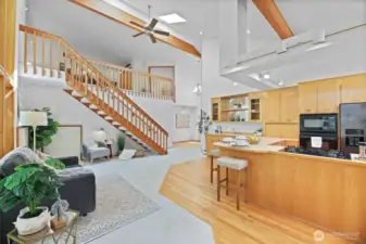 Open-concept family room and kitchen complete with island seating and wet bar.