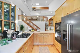 Open-concept family room and kitchen complete with island seating and wet bar.