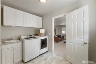 Large utility room with sink & cabinet space.
