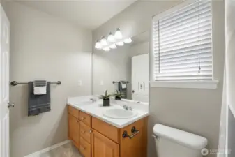 Upstairs second full bath w/two sinks, tub/shower combo.