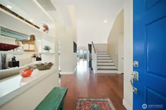 Step into a radiant foyer with soaring cathedral ceilings, polished hardwood floors, and an abundance of natural light.