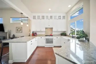 The updated kitchen boasts stunning granite countertops, plentiful storage, and convenient pull-out cabinetry.